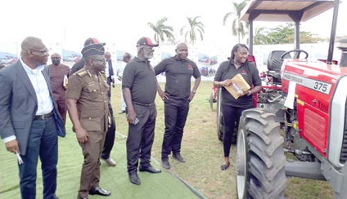   Kalysta Darko-O'kell (right), Managing Director, Mechanical Lloyd Company Limited, exhibiting one of the tractors at the event. Picture: ELVIS NII NOI DOWUONA 